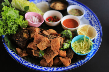 selective focus of fried fish salad with Thai herb for healthy eating in dailiy life.