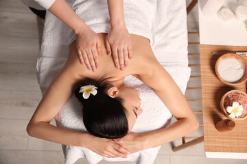 Obraz na płótnie Canvas Beautiful woman receiving back massage in beauty salon, closeup. Top view