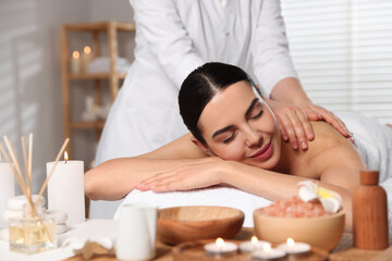 Fototapeta na wymiar Beautiful woman receiving back massage in beauty salon, closeup