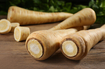 Fresh ripe parsnips on wooden table, closeup