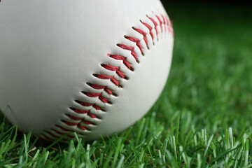 Baseball ball on green grass, closeup. Sports game