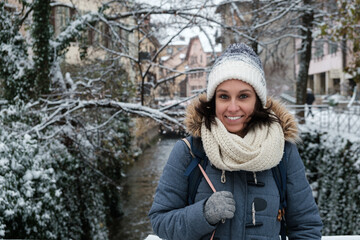 smily Girl with a hat posing in front of a canal