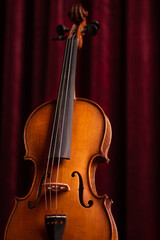 Fototapeta na wymiar Retro vintage violin on red theater curtains background