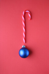 Merry Christmas card. Christmas festive candy cane on a red background
