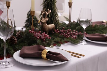 Beautiful table setting with Christmas decor indoors