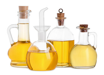 Different glass bottles of cooking oil on white background