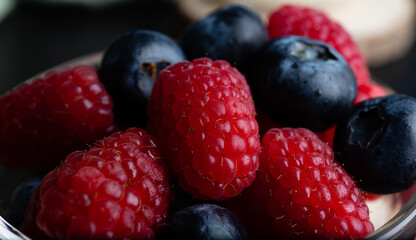 Heap of raspberries mixed with blueberries, vegan concept.