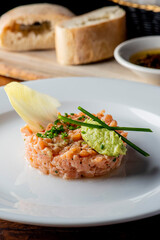 Tuna tartare. Raw Tuna dish that combines raw seafood, fish and a citrus sauce. Tuna is chopped in pieces and then mixed with the sauce. Tuna Tartare is traditional to Japanese cuisine.