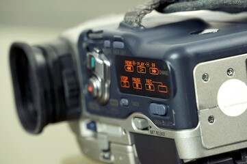 Fototapeta na wymiar digital video camera. Closeup on mini-dv camcorder play. Digital video camcorder on vcr mode. 