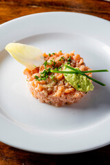 Tuna tartare. Raw Tuna dish that combines raw seafood, fish and a citrus sauce. Tuna is chopped in pieces and then mixed with the sauce. Tuna Tartare is traditional to Japanese cuisine.