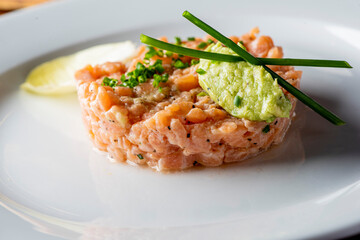 Tuna tartare. Raw Tuna dish that combines raw seafood, fish and a citrus sauce. Tuna is chopped in pieces and then mixed with the sauce. Tuna Tartare is traditional to Japanese cuisine.