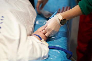 a nurse takes a blood sample.Close up Hand of a nurse or doctor in gloves taking a blood sample from a patient in a hospital. Close up Of Doctor Injecting Patient With Syringe To Collect Blood Sample