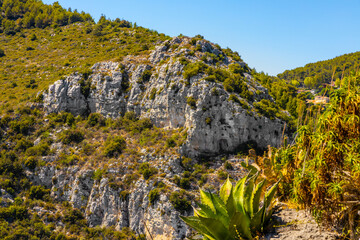 Panoramic view of Alpes rocky coastline with Avenue Bella Vista route on Azure Cost of Mediterranean Sea seen from historic town of Eze in France