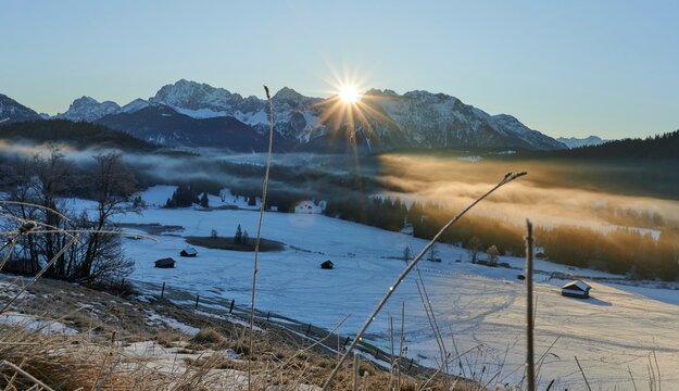 View over the Geroldsee  to the Karwendel mountains with fog at sunrise in winter, Alps, Bavaria, Germany