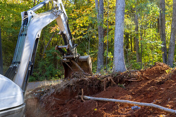 Trees need be uprooted and land to prepared for construction with tractor