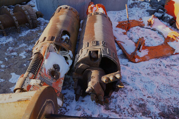 Machine parts for setting bored piles in snow on a construction site in Halle an der Saale