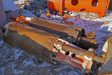 Machine parts for setting bored piles in snow on a construction site in Halle an der Saale