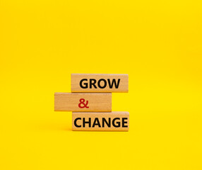 Grow and Change symbol. Concept word Grow and Change on wooden blocks. Beautiful yellow background. Business and Grow and Change concept. Copy space
