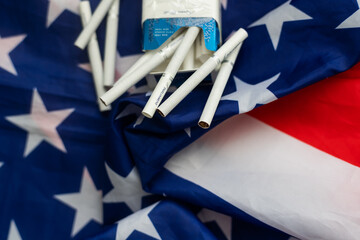 Transportation of illegal tobacco goods. Cigarettes on background of flag USA