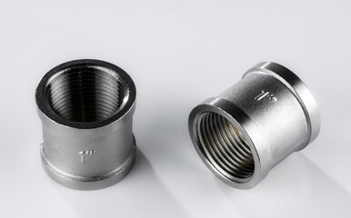 Two regular couplings of white metal with internal thread 1 inch.