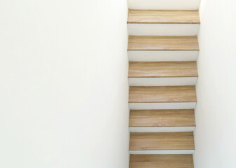 top view of wood house stairs with white wall