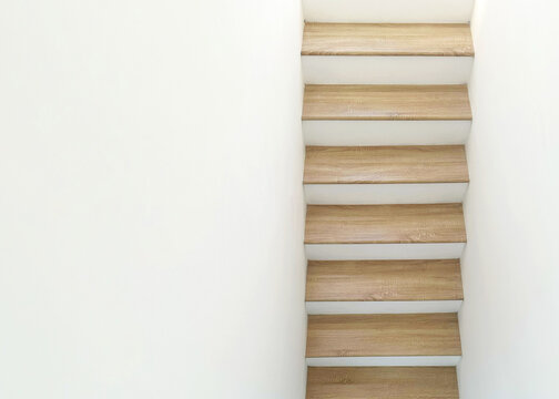 top view of wood house stairs with white wall - Powered by Adobe