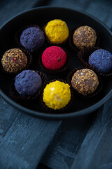 Sweets multicolored round on old wooden background