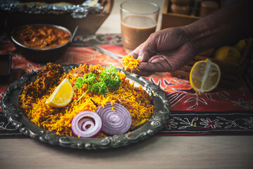 Close-up of Indian man's hand Picking up Indian food, which is to food culture of Indians, to...