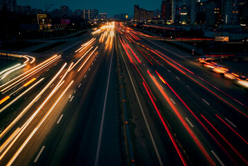 Rush hour traffic shot from above over a busy road showing streaking trails of light of blurred cars 
