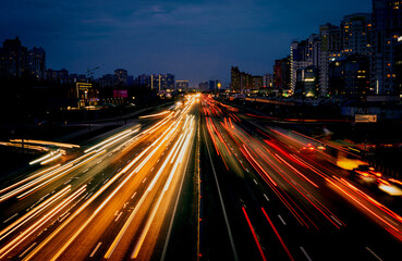 Fototapeta premium Rush hour traffic shot from above over a busy road showing streaking trails of light of blurred cars 
