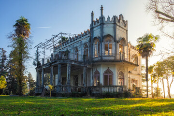 Old abandoned house or mansion in sunny day. Vintage haunted building