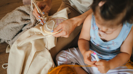Mother teaching daughter girl knit, sewing accessories. Many object for needlework, handmade and handicraft. Creative craft project