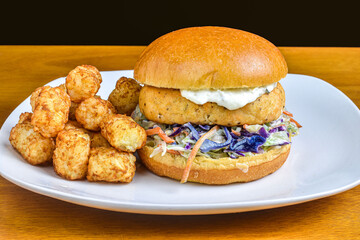 salmon resting on cole slaw on a broiche roll