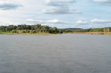 spring landscape of a lake on a sunny day with some clouds