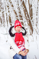 Fototapeta na wymiar Portrait of happy young woman in winter forest