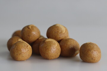Fototapeta premium Moong dal laddu. A Protein rich, Indian sweet ball made of lentils, almonds and jaggery as sweetener. Moong dal laddus are a delicious treat and a nice way to end a meal