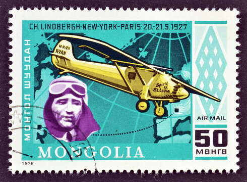 Cancelled postage stamp printed by Mongolia, that shows Charles A. Lindbergh, Spirit of St. Louis, 75th Anniversary of First Powered Flight, circa 1978.