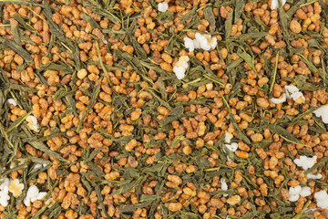 Green tea Japanese Genmaicha background. Green tea mixed with roasted popped brown rice filling the frame.