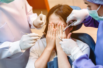 Dentist examining teeth patients in clinic for better dental health and a bright smile.The patient...
