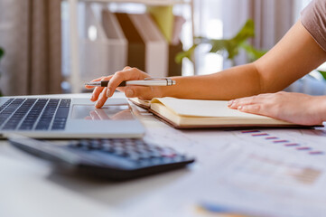 Working at home office hand on keyboard,owner business woman work at home for online shopping,writing the order and preparing package product with office equipment, entrepreneur life style concepts.