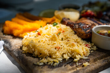 plate of rice with vegetables on a wooden board