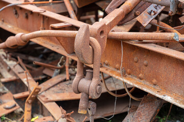 Photograph of old and rusty heavy duty metal hook attached to a large D-Bolt at the end of an...
