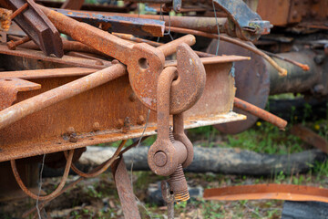 Photograph of old and rusty heavy duty metal hook attached to a large D-Bolt at the end of an unused
and scrapped rail carriage