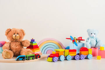 Educational kids toys collection. Teddy bear, train, airplane, rainbow, wooden musical, sensory, sorting and stacking baby toys, on white background. Sustainable, eco-friendly toys. Front view