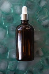 Cosmetic product packaging on menthol ice cubes. Mockup.