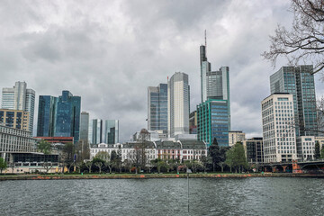 Fototapeta na wymiar Modern skyscrapers, corporate and commercial buildings in the financial district of Europe, Germany, Frankfurt. View of tall glass buildings against cloudy sky
