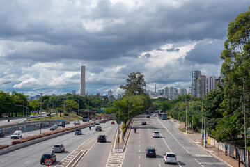 traffic in the city of Sao Paulo, Brazil, with the cityscape on the background where it's possible to see the obelisk