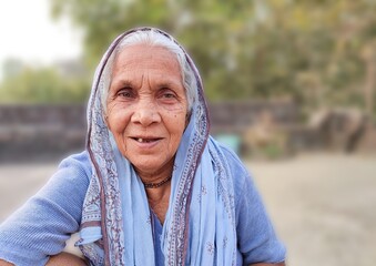 Old lady woman of the rural area of India, smiling, mother, nanny, and grandmother, people live in the village of the India and indian culture