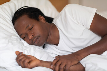Fototapeta na wymiar Closeup Shot Of Young African American Guy Sleeping In Bed At Home