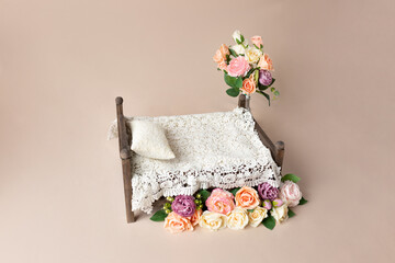 bed for a photo shoot, decorated with flowers. newborn photography furniture background decor for the photo zone. empty space for a child. photo template